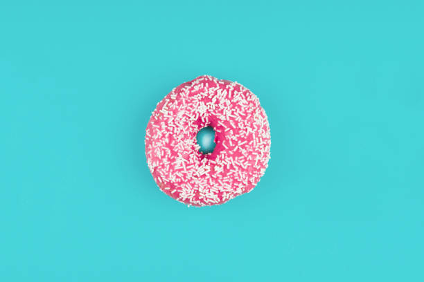 istock Pink donut on color background, flat lay, top view 2153879303
