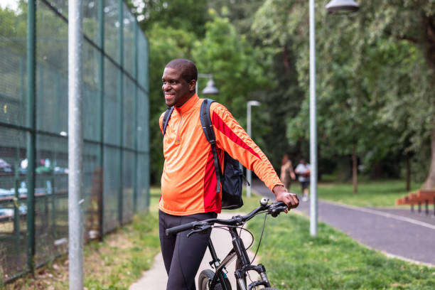 istock Man taking a break from a bike ride in a park 2153880646