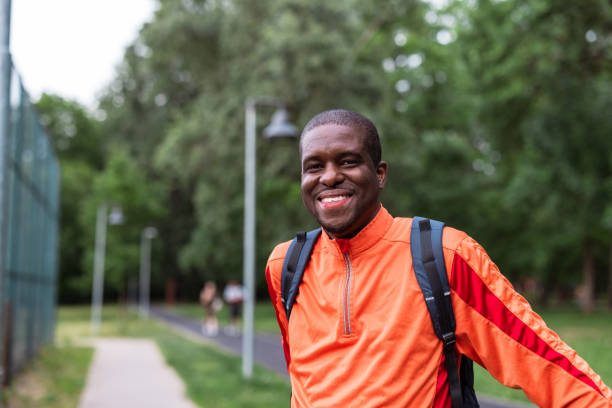 istock Happy man in sportswear smiling outdoors in a park 2153880748