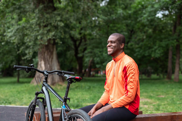 istock Smiling cyclist taking a break in a park 2153880893