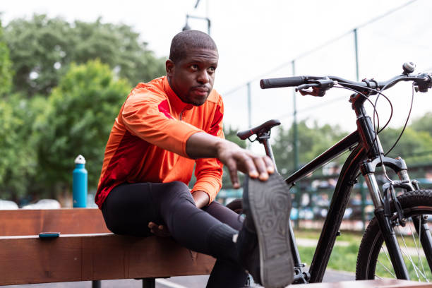 istock Man stretching legs before cycling exercise outdoors 2153880911