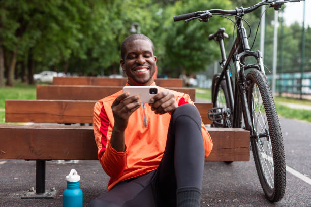 istock Happy man taking a break from cycling and using smart phone 2153880948