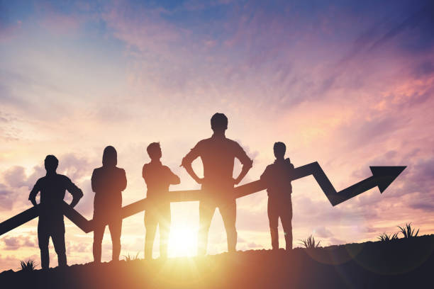istock Team silhouette and up graph arrow on sunset background, leadership and teamwork concept 2153881502