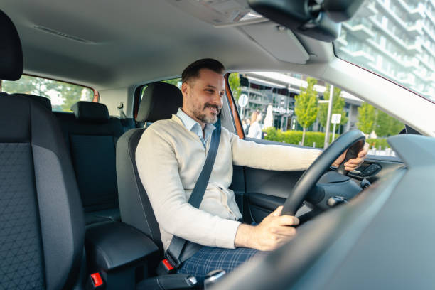 istock Handsome man driving car in the city 2153889487