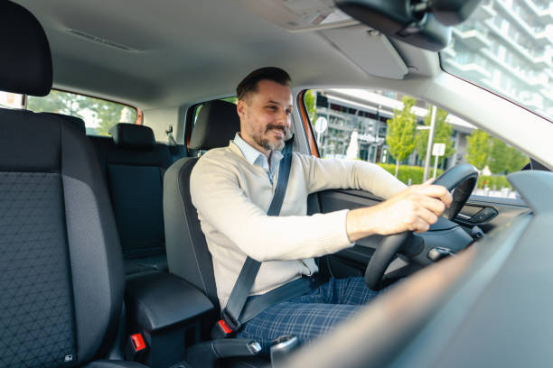 istock Handsome man driving car in the city 2153889490