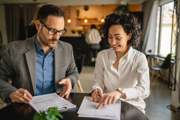 istock Man and woman colleagues hold documents and work together at cafe 2153889523
