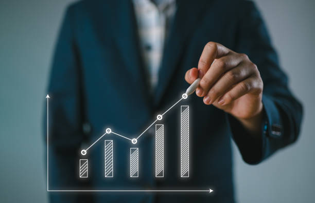 Businessman drawing upward trend bar chart.