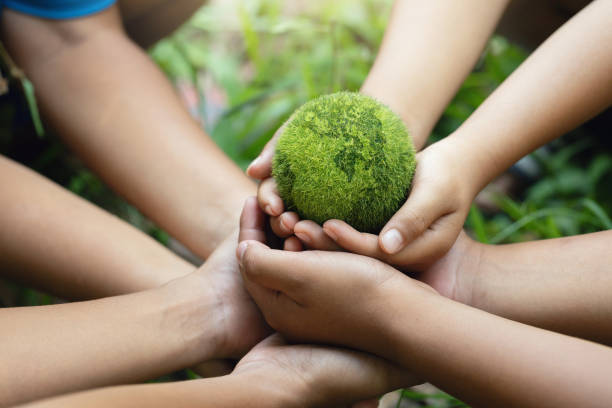 istock Environment Earth Day In the Children's hands holding green earth, Saving the environment, Save Earth. Environment World Earth Day. Protecting Planet Together. Environmentally sustainable.ESG 2153897743