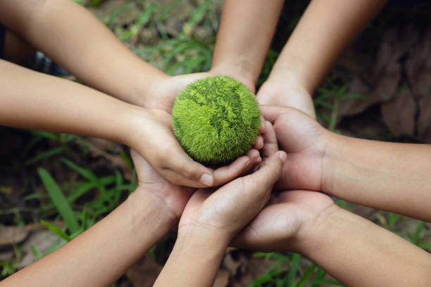 istock Environment Earth Day In the Children's hands holding green earth, Saving the environment, Save Earth. Environment World Earth Day. Protecting Planet Together. Environmentally sustainable.ESG 2153897760