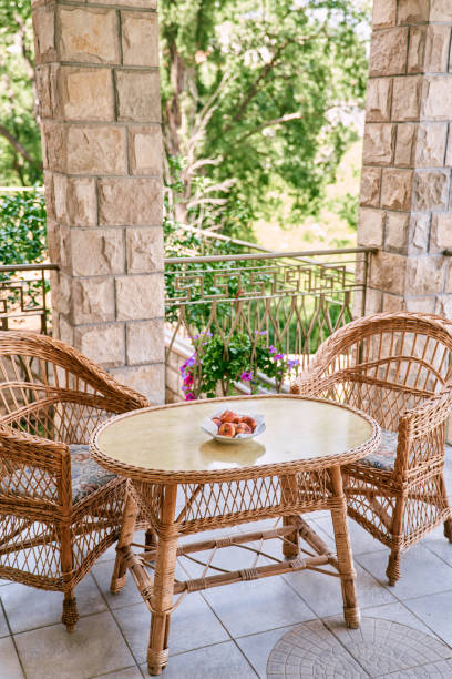 istock Peaches lie in a plate on a table with wicker chairs standing nearby 2153903350