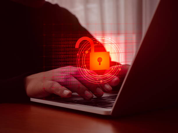 istock Cyberattack and internet crime, scam, hacking and malware concepts. Unlocked padlock icon on red digital binary code data numbers on dark virtual screen while hacker's hands typing on laptop computer. 2153905829