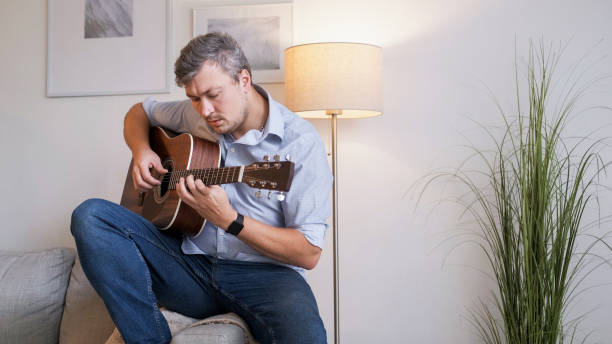 istock Guitar inspiration melody practicing man home 2153906690