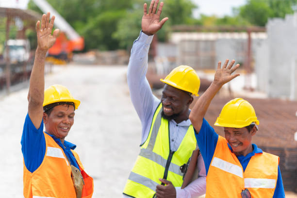 istock Happy Foreman worker team making high hands over head, Success and Teamwork Concepts 2153911501