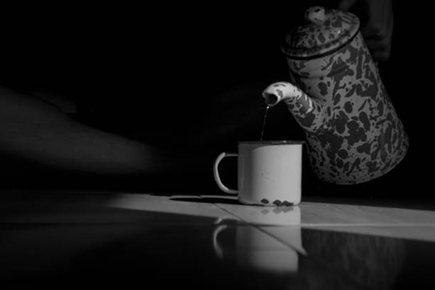 istock Someone poured water from an enamel teapot into a cup 2153911502