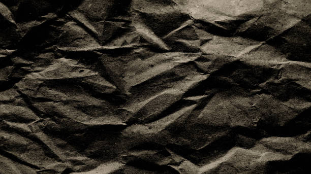 istock Rough and wrinkled paper texture background with dark gray-brown gradient. For backgrounds, frames, articles, dark scenes. 2153911728