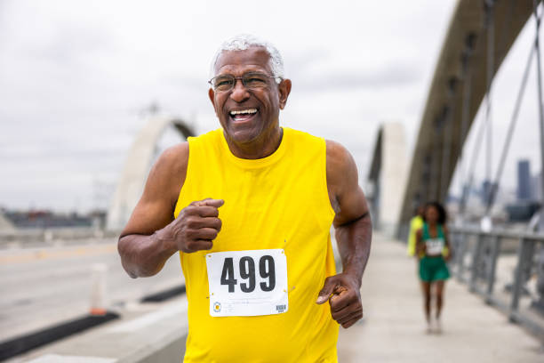 istock Senior black man running in a marathon 2153911981