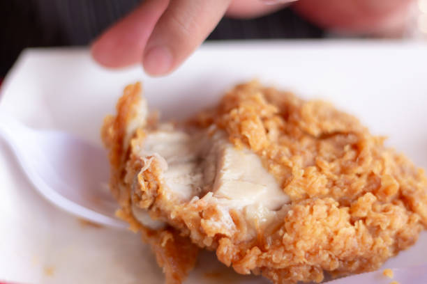 istock Woman eating fried chicken blurred background 2153913053