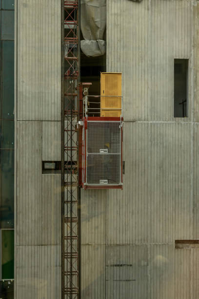 istock Lift at a construction site. Construction hoist lifting a load at a construction site 2153915268