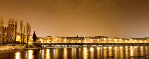 Snowy Adige riverbanks in the old town of Verona, one of the most popular and visited cities in Veneto, whose historic centre has been declared a Unesco World Heritage Site