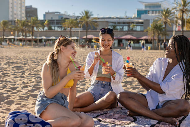istock Friends Enjoying Refreshing Drinks at the Beach 2153920740