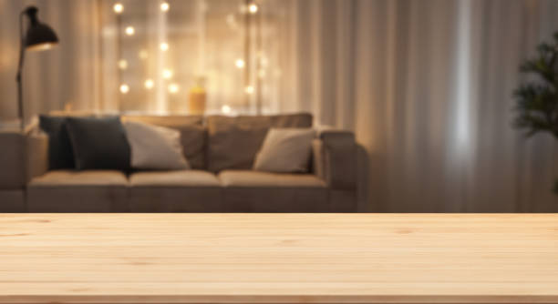 Empty wood table top with evening living room