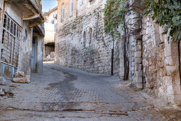 Street with old stone houses with green ivy on the walls