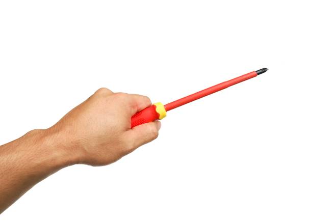 istock A man's hand holds a yellow and red tool called a screwdriver for use in general mechanical, electrical, and general mechanics work.  Equipment for tightening nut heads isolated on white background. 2153922344