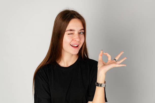 istock Young Woman Making OK Sign With Fingers 2153922492