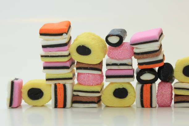 Stacked liquorice allsorts in different shapes, colors and sizes