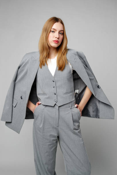 istock Woman in Gray Suit and White Shirt posing in studio 2153926655