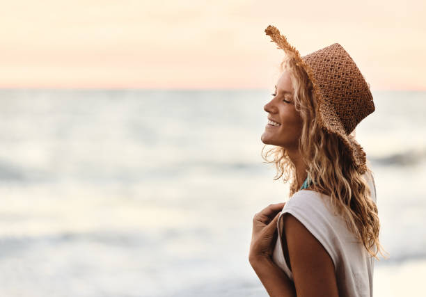 istock Happy woman with a straw hat on the beach. 2153926795
