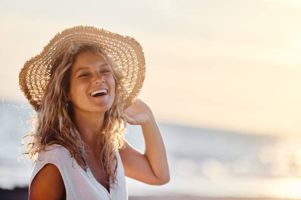 istock Cheerful woman with sun hat on the beach. 2153926880