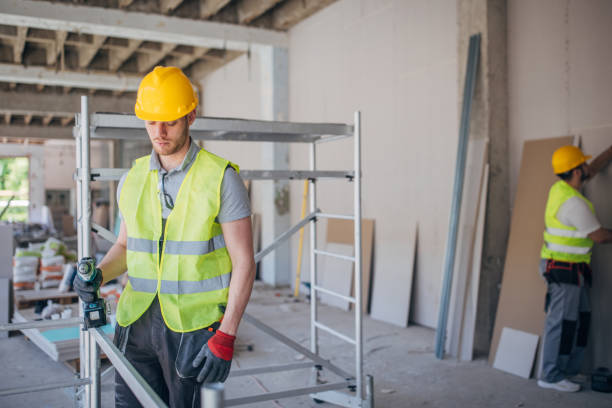 istock A diligent construction worker meticulously secures a metal beam at a bustling building site 2153927869