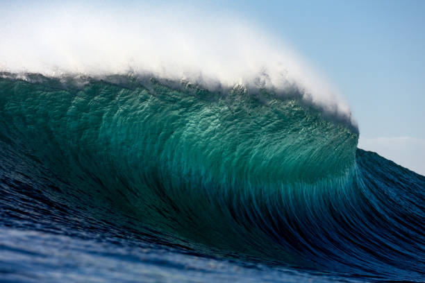 istock A large turquoise wave curling over a shallow reef 2153928041