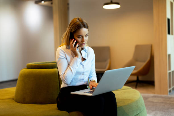istock Businesswoman working on laptop while on a call in a modern office 2153929929