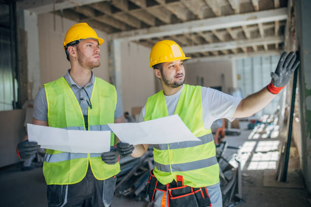 istock Strategic Planning on Site: Construction Workers Reviewing Blueprints 2153930201