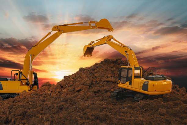 istock Two excavators are digging the soil in the construction site 2153930763
