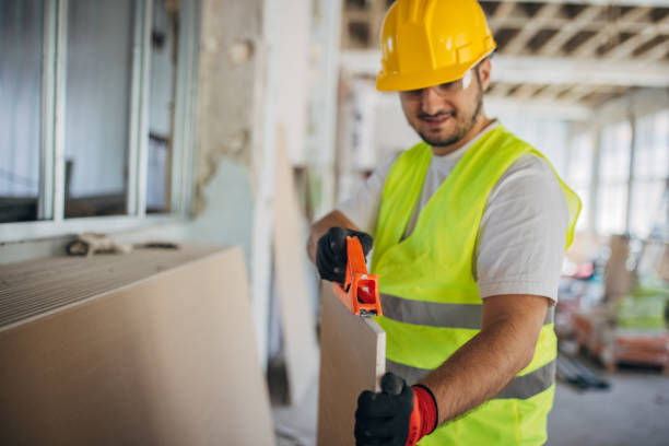 istock Precision at Work: Construction Worker Fastens Drywall with Electric Screwdriver 2153931474