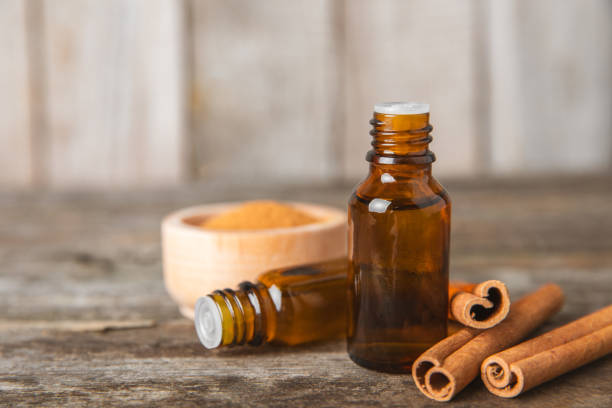 istock Cinnamon aromatic essential oil and cinnamon sticks on background. Aromatherapy. Organic cosmetic oil. Spa concept. Place for text. Copy space. 2153932157