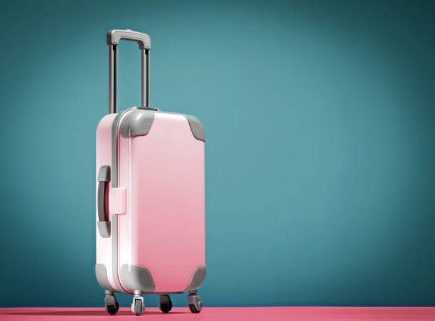 istock Pink suitcase on blue and pink background. Copy space. 2153932257