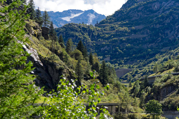 istock Looking up Gotthard mountain pass with mountain pass road and narrow valley. 2153932479