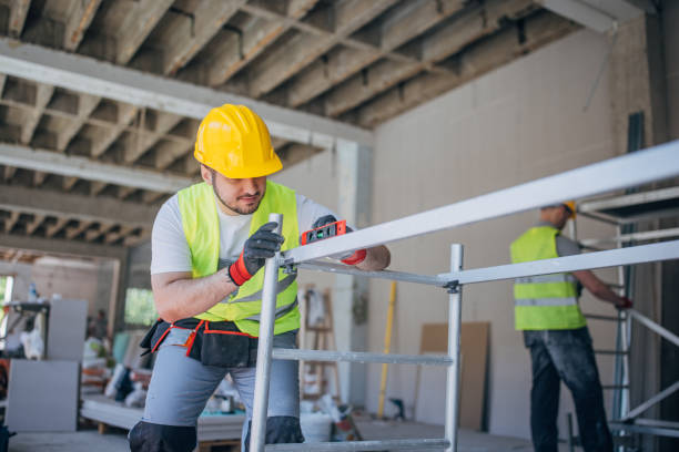 istock A diligent construction worker meticulously secures a metal beam at a bustling building site 2153932892