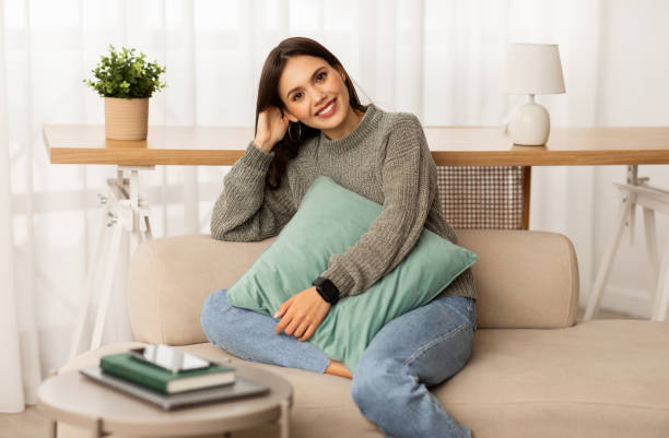 istock Cheerful young lady freelancer resting on couch at home 2153933303