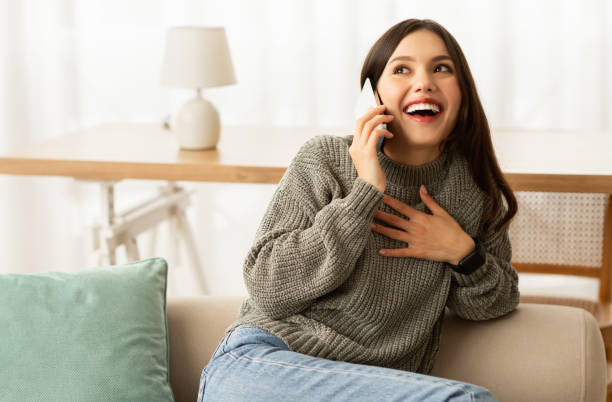 istock Mobile Communication. Beautiful Woman Talking On Cellphone At Home 2153933345