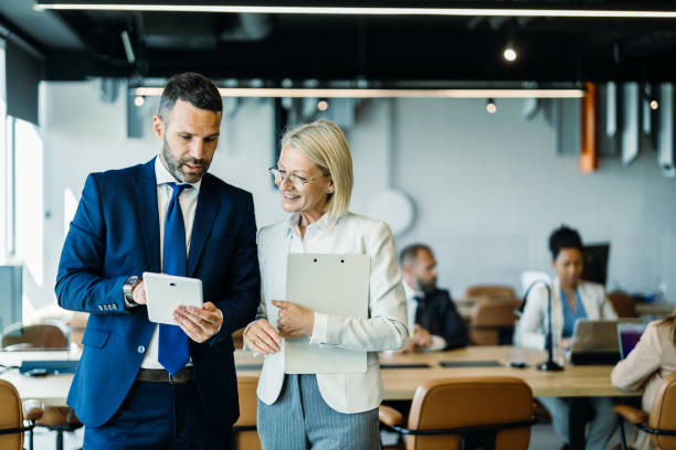 istock Business partners using a tablet in a discussion 2153935597