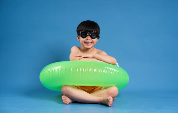 Above shot of teenage girl lying on inflatable raft, smiling and looking at camera