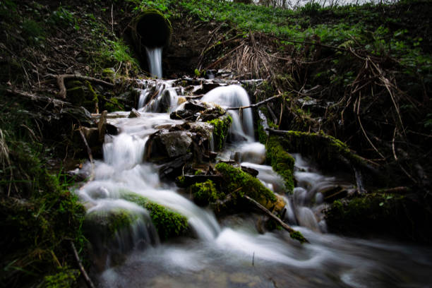 istock In the woods, a pipe releases water forming a beautiful waterfall 2153936008