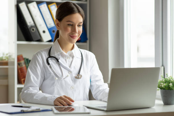 istock Medical practitioner woman working at laptop 2153936409