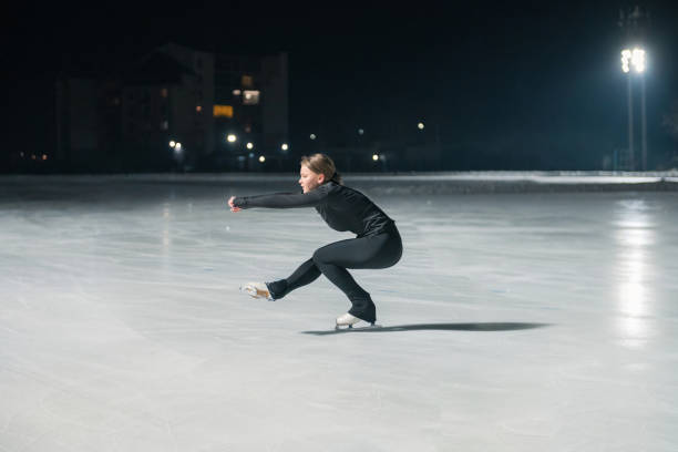 istock Beautiful young woman ice skating 2153939127