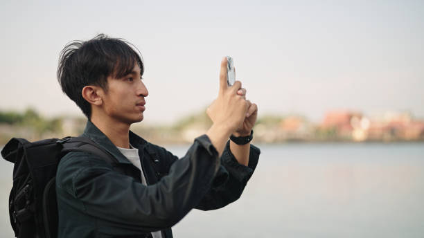 istock Asian man traveling at riverside. 2153939569